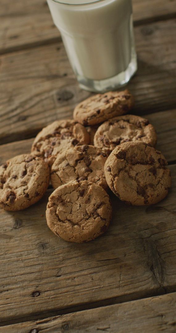 Homemade Chocolate Chip Cookies with Milk on Rustic Table