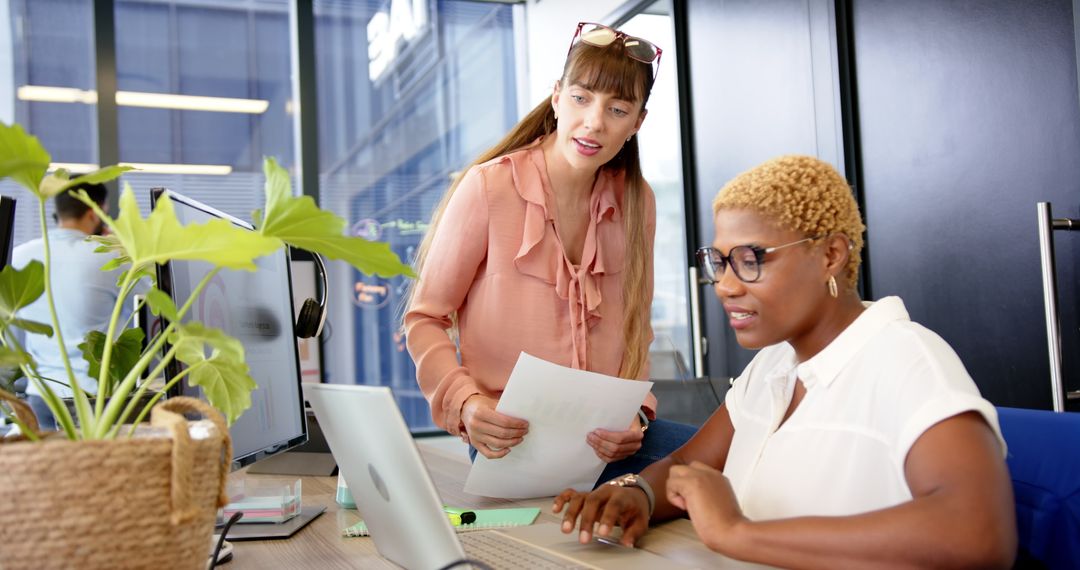 Two Professional Women Collaborating on Work Project