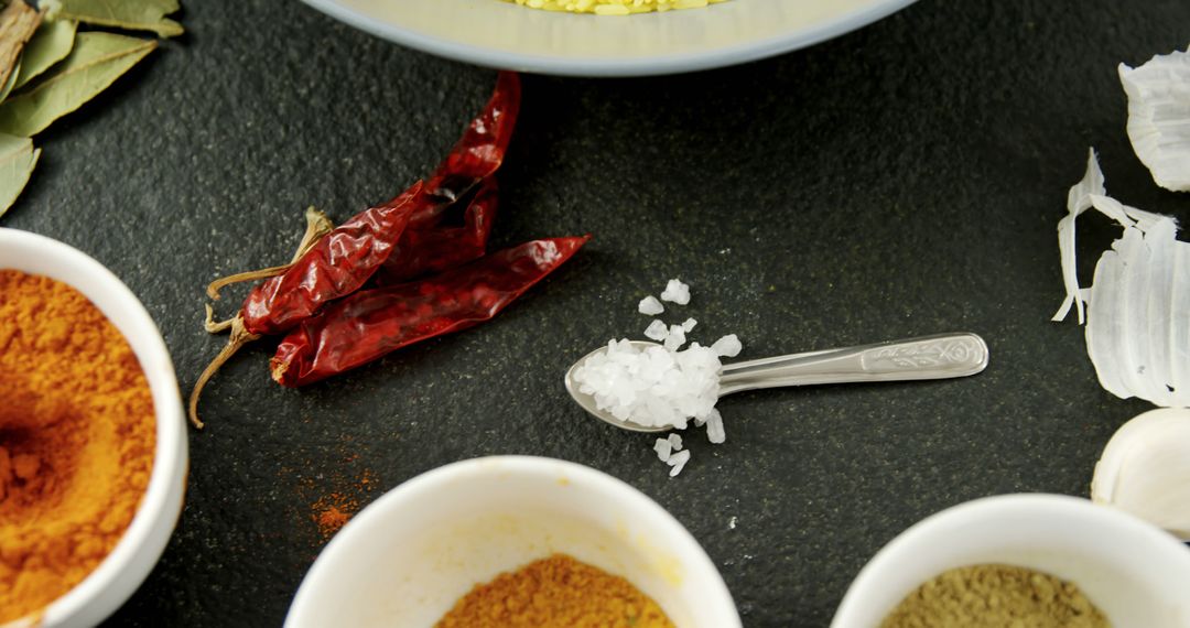 Assorted Indian Spices with Chilli Peppers on Black Slate Background - Free Images, Stock Photos and Pictures on Pikwizard.com