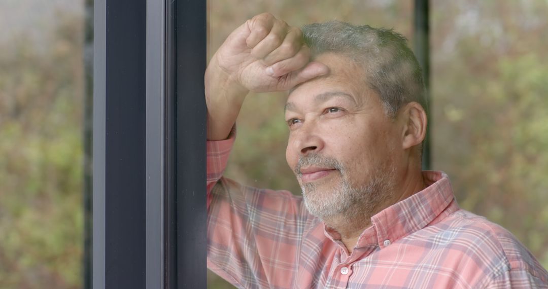 Man Pondering While Looking Out Window - Free Images, Stock Photos and Pictures on Pikwizard.com