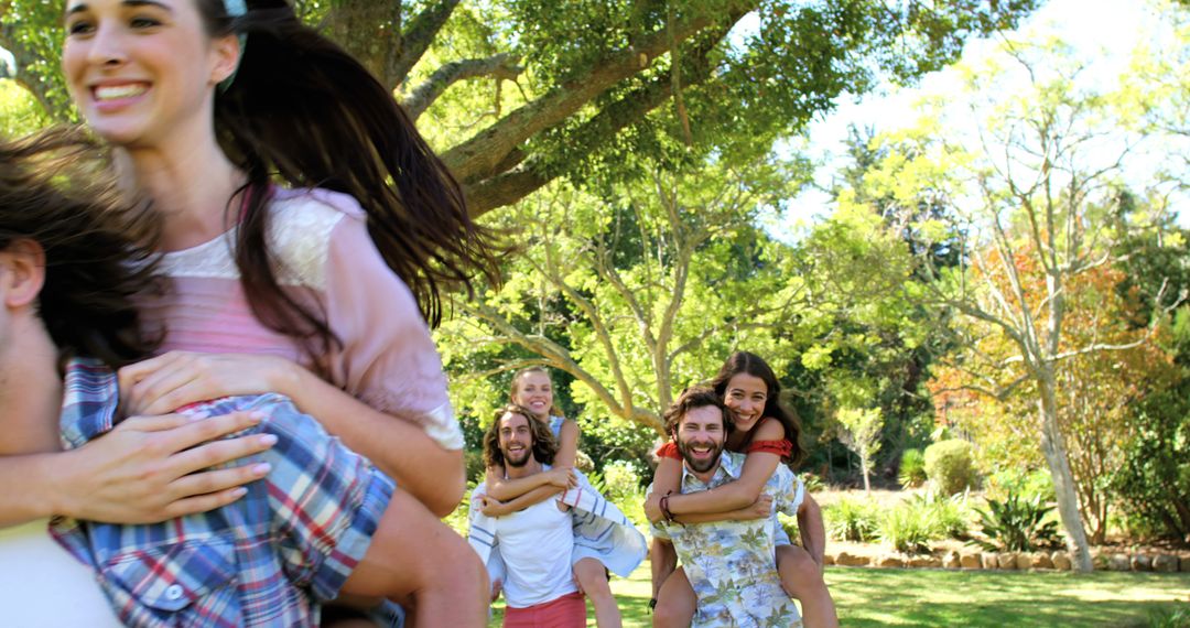 Group of Friends Playing Piggyback in Outdoor Park - Free Images, Stock Photos and Pictures on Pikwizard.com