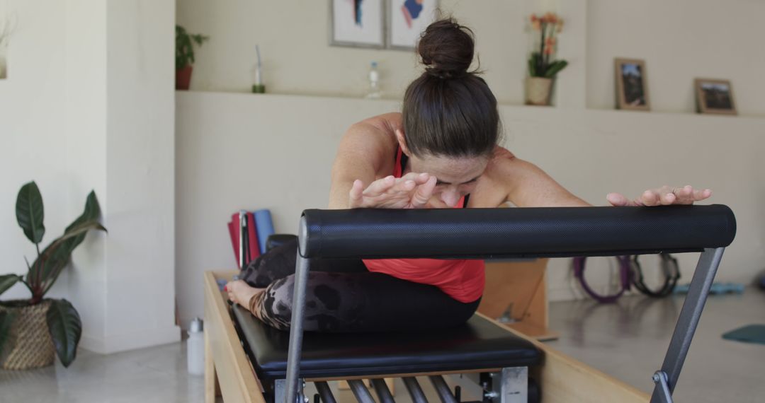 Woman Practicing Pilates on Reformers in Home Workout Space - Free Images, Stock Photos and Pictures on Pikwizard.com