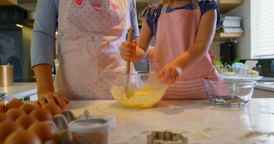 Mother and daughter baking together in cozy home kitchen - Free Images, Stock Photos and Pictures on Pikwizard.com