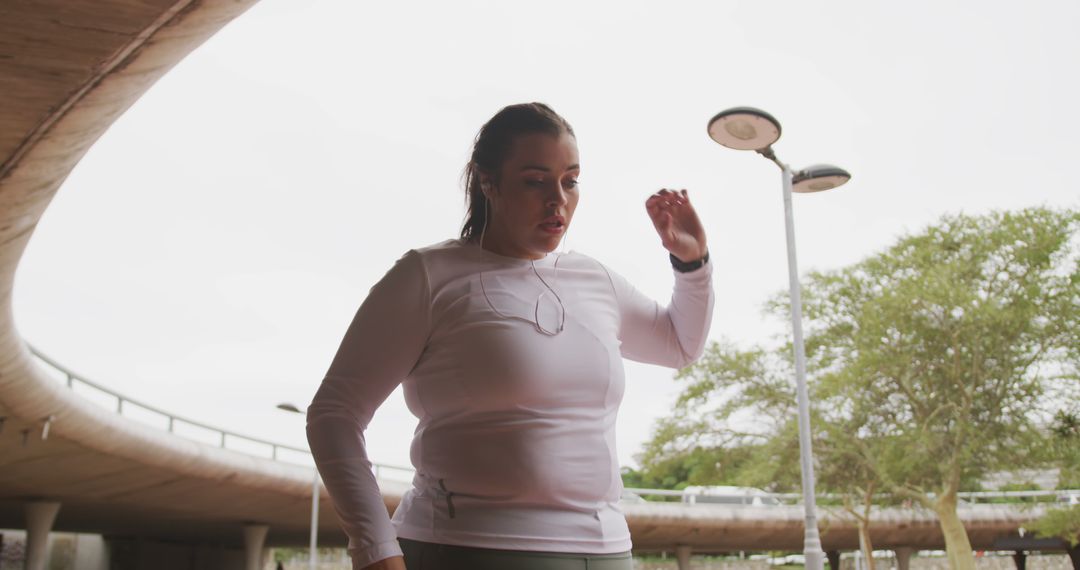 Young Woman Checking Smartwatch After Workout Outdoors - Free Images, Stock Photos and Pictures on Pikwizard.com