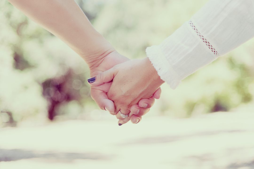 Romantic Couple Holding Hands with Engagement Rings Outdoors - Free Images, Stock Photos and Pictures on Pikwizard.com