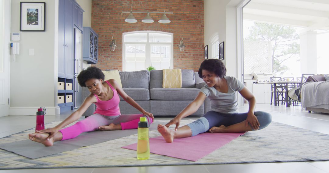 Mother and Daughter Enjoying Yoga Session at Home - Free Images, Stock Photos and Pictures on Pikwizard.com