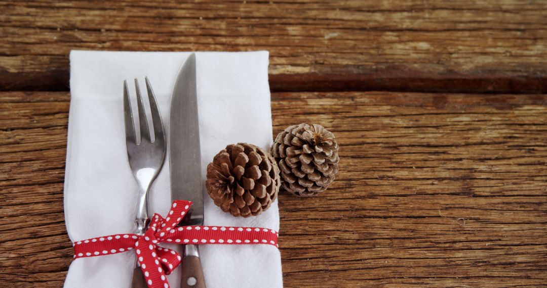 Rustic Holiday Table Decoration with Pinecones and Cutlery - Free Images, Stock Photos and Pictures on Pikwizard.com