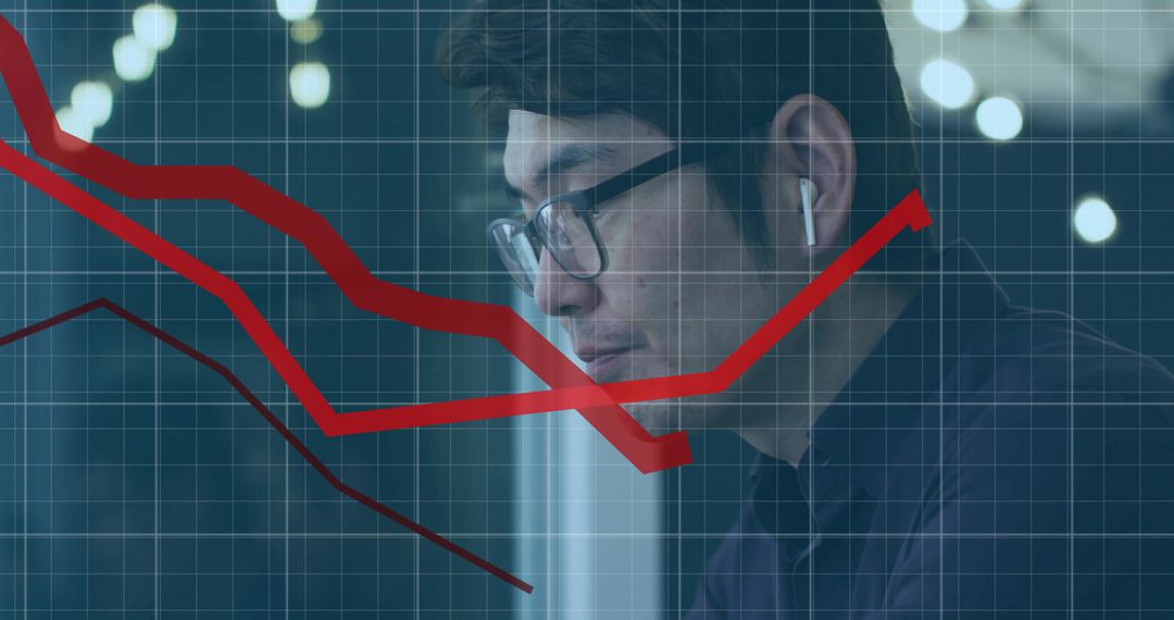 Asian Professional Analyzing Declining Line Charts with Technology