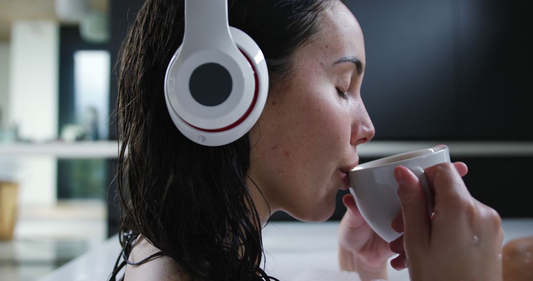 Woman Relaxing in Bath Listening to Music with Headphones and Drinking Coffee - Free Images, Stock Photos and Pictures on Pikwizard.com