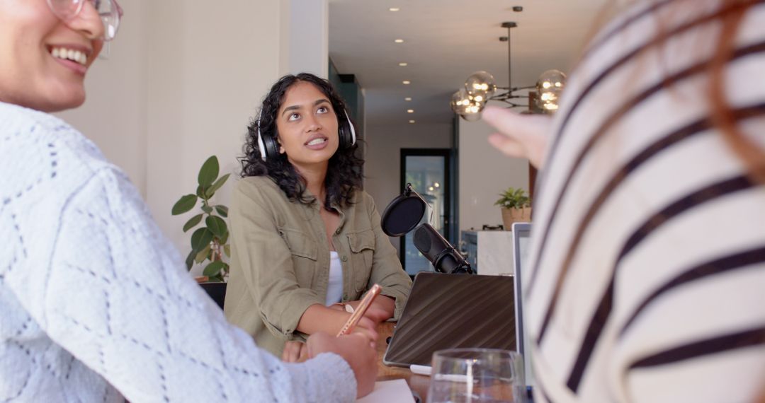 Diverse Female Collaborators Discussing Podcast in Modern Studio
