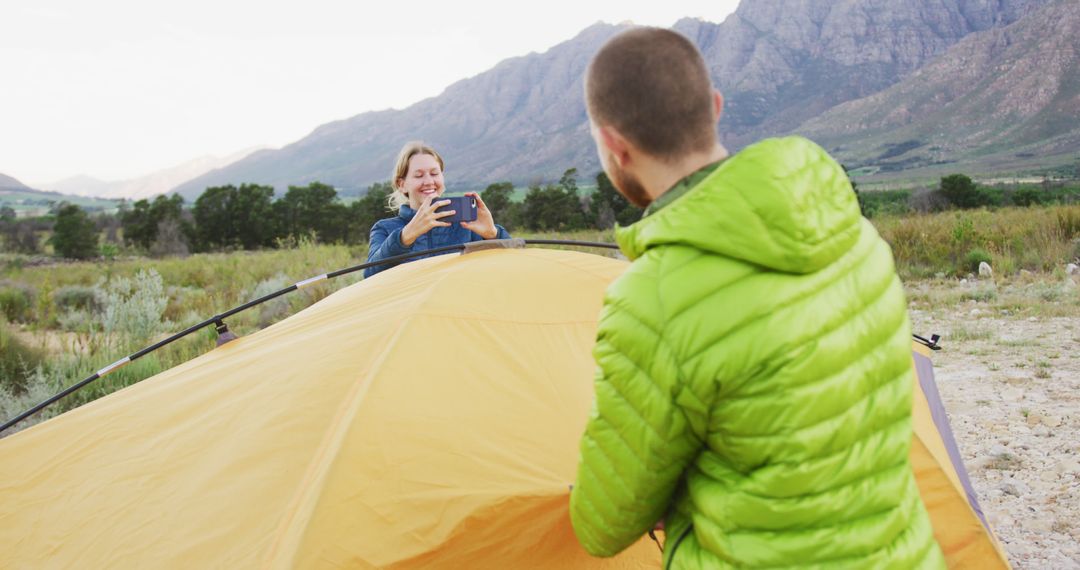 Couple Capturing Camping Memories in Mountain Landscape - Free Images, Stock Photos and Pictures on Pikwizard.com