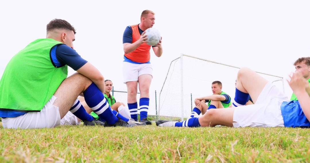 Soccer Team Preparing for Match with Coach Instructions