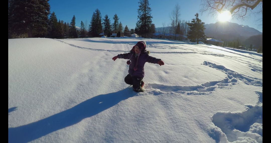 Child Enjoying Snowy Winter Landscape in Bright Sunshine - Free Images, Stock Photos and Pictures on Pikwizard.com