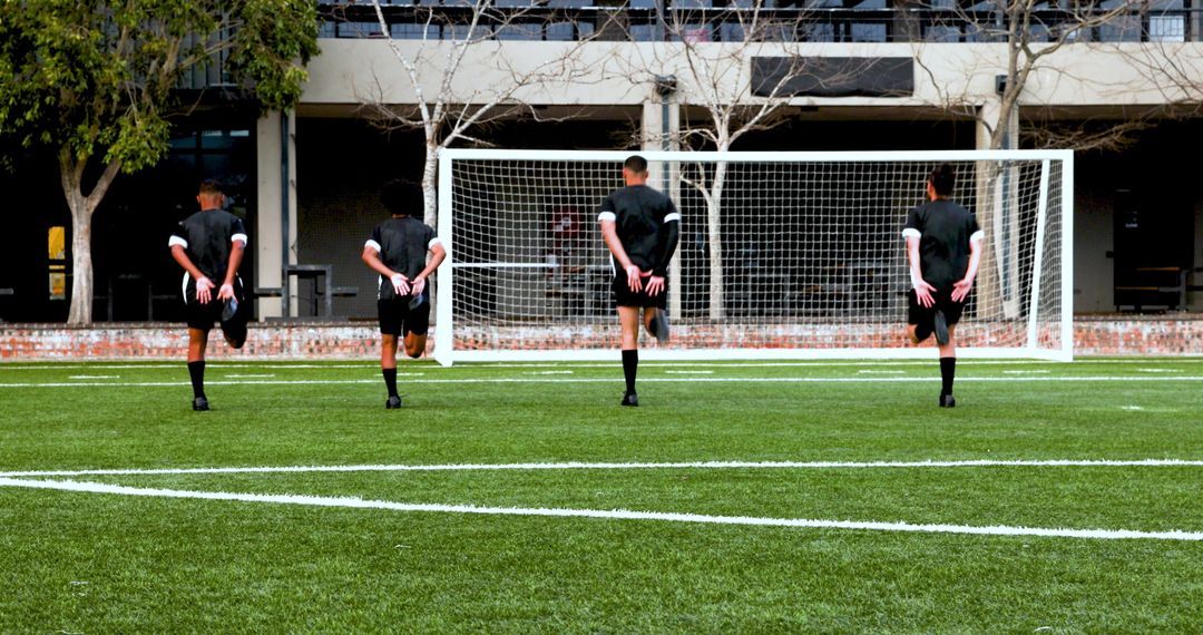Soccer Players Warming Up on Field for Outdoor Practice