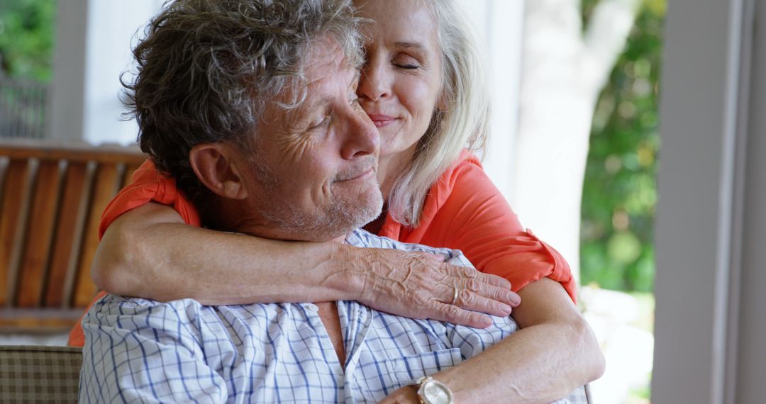 Senior Couple Embracing at Home in Warm Moment