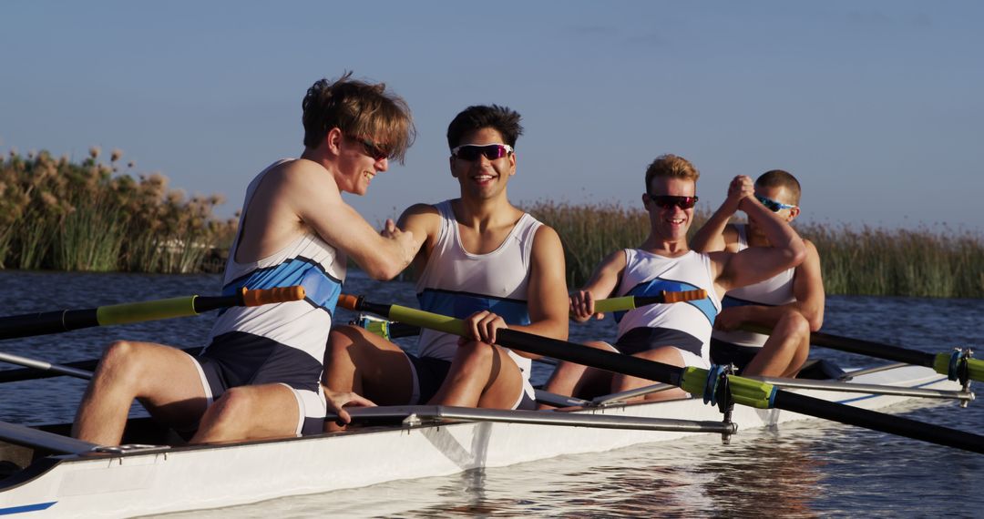 Team of Rowers Celebrating Victory on Calm Lake - Free Images, Stock Photos and Pictures on Pikwizard.com