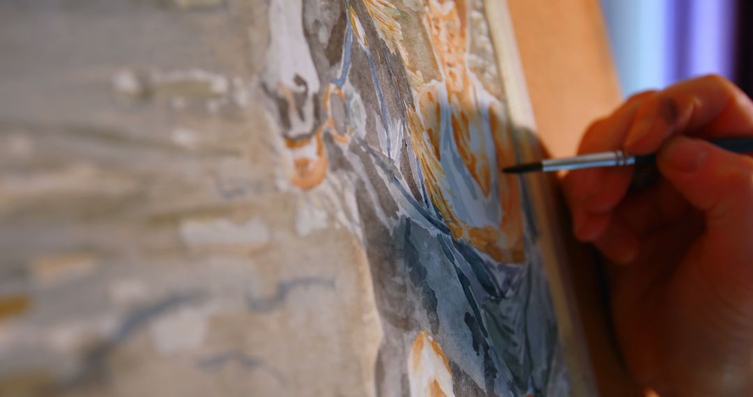 Close-up of Artist Delicately Painting on Canvas with Brush