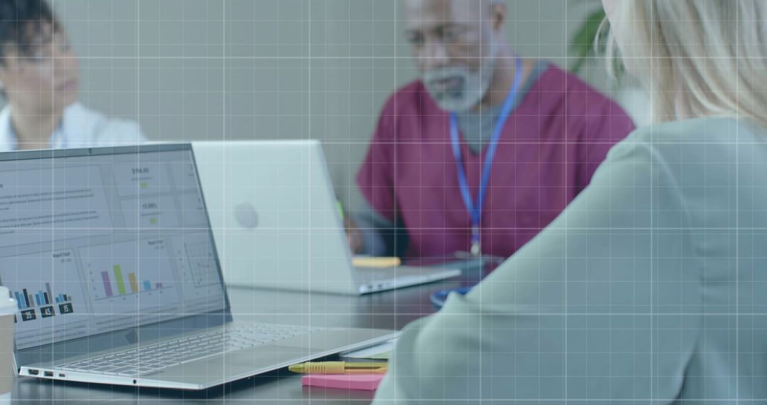 Diverse Medical Team Analyzing Financial Data on Laptops