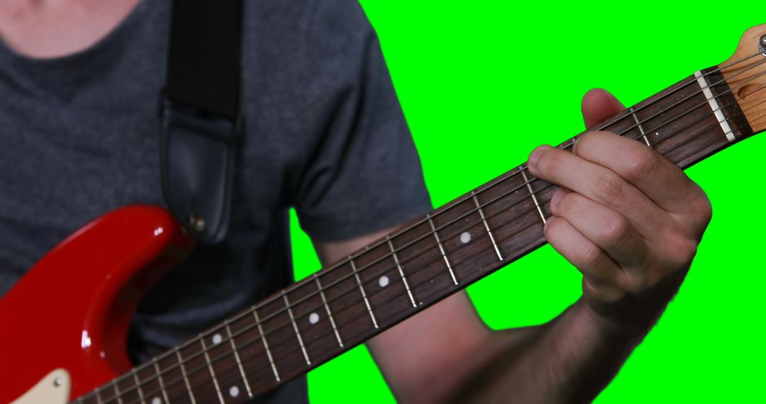 Close-Up of Person Playing Electric Guitar With Green Background - Free Images, Stock Photos and Pictures on Pikwizard.com