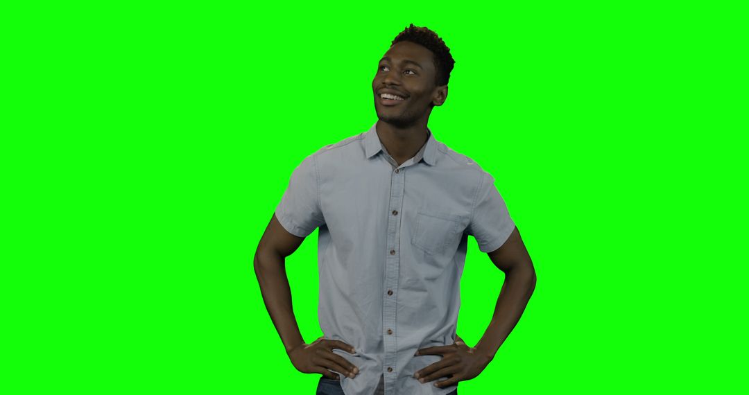 Confident African American man posing on green screen - Free Images, Stock Photos and Pictures on Pikwizard.com