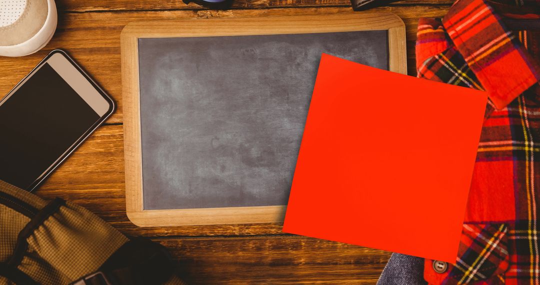 Blank Red Memo Note on Desk with Blackboard Background
