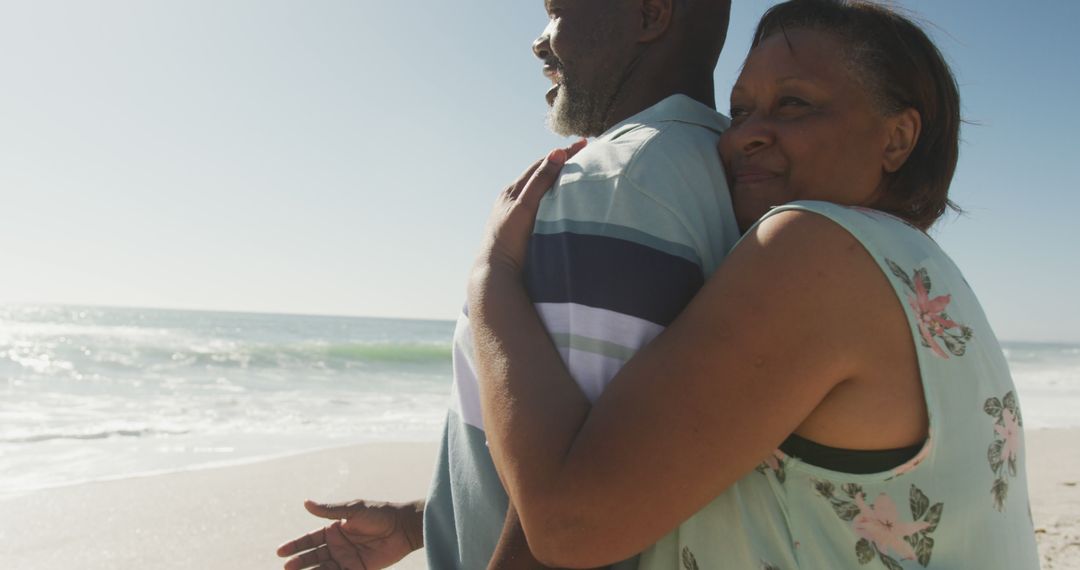 Senior African American Couple Embracing on a Beach - Free Images, Stock Photos and Pictures on Pikwizard.com