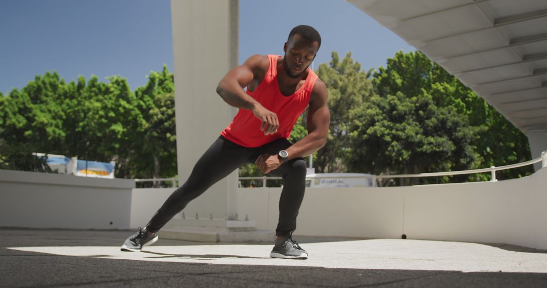 Athletic African American Man Stretching Outdoors in Sunny Weather - Free Images, Stock Photos and Pictures on Pikwizard.com