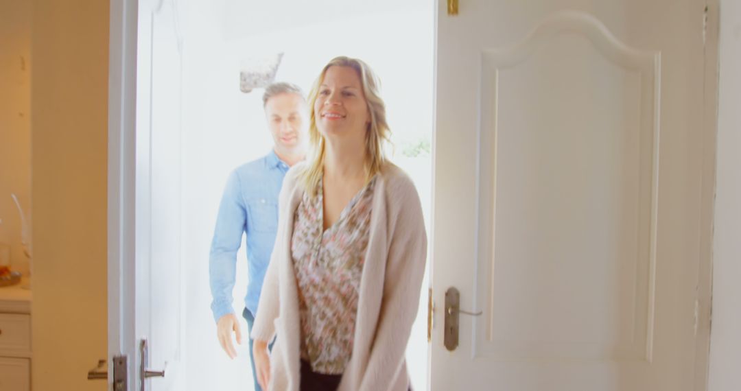 Couple Entering Home Smiling Together - Free Images, Stock Photos and Pictures on Pikwizard.com