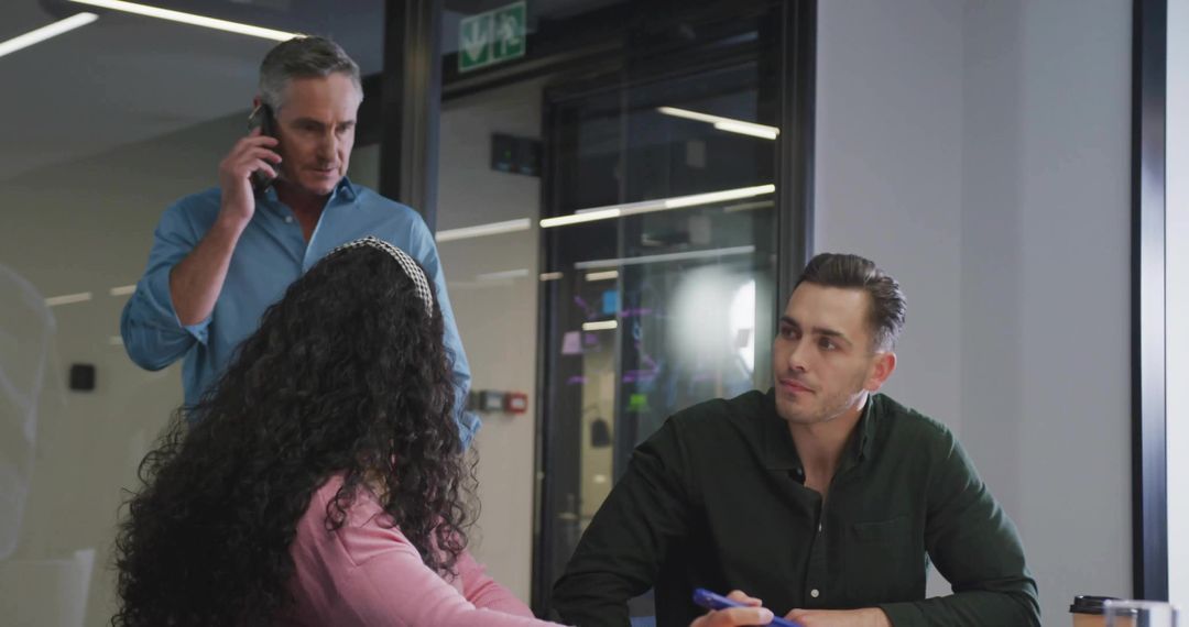 Three Colleagues Engaging in Professional Meeting Environment