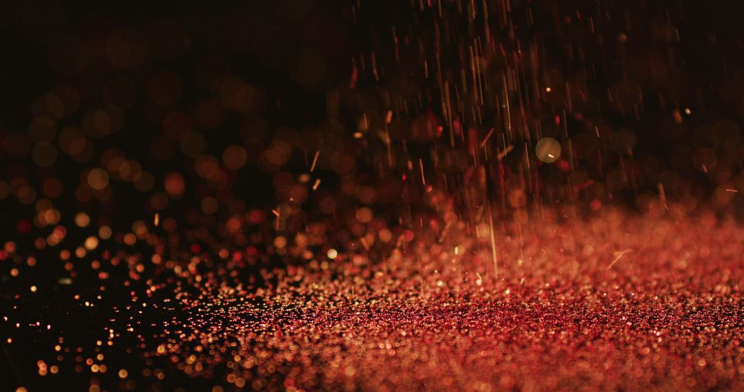 Shimmering Red Glitter Falling on Black Surface