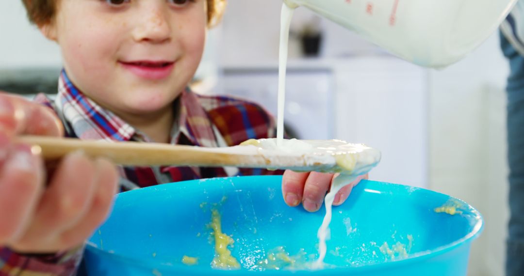 Smiling Child Mixing Batter in Kitchen - Free Images, Stock Photos and Pictures on Pikwizard.com