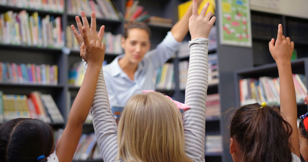 Engaged Students Raising Hands During Library Lesson