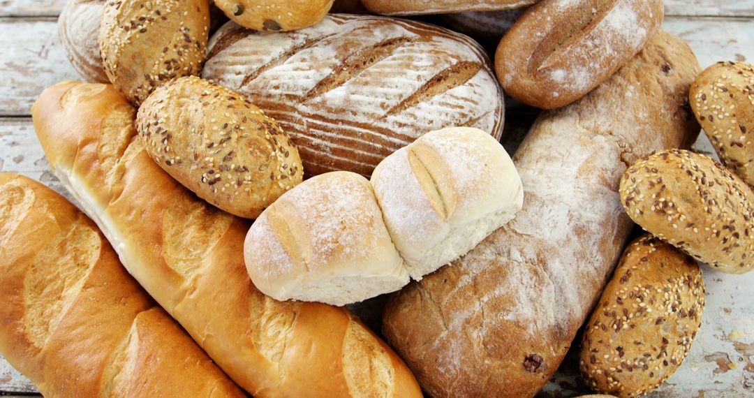 Assorted Freshly Baked Bread Loaves and Rolls on Wooden Background - Free Images, Stock Photos and Pictures on Pikwizard.com