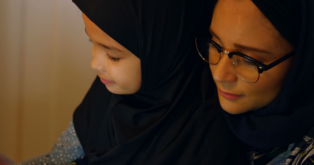 Muslim Mother and Daughter Reading Together at Home - Free Images, Stock Photos and Pictures on Pikwizard.com