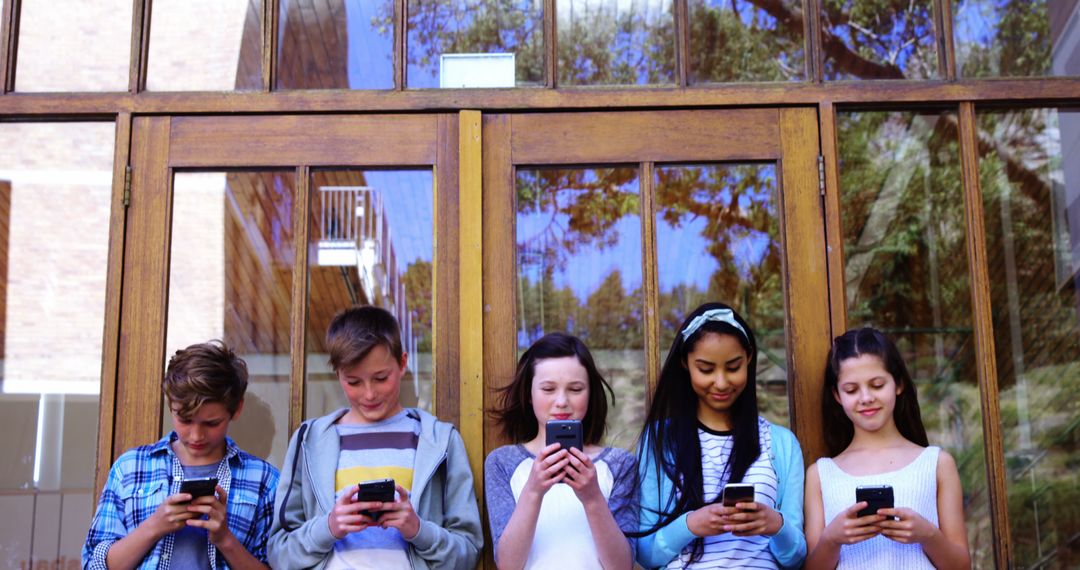 Diverse Group of Kids Standing Outdoors Using Smartphones - Free Images, Stock Photos and Pictures on Pikwizard.com