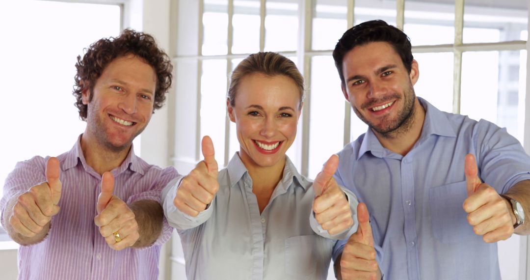 Group of Professionals Giving Thumbs Up in Office Environment - Free Images, Stock Photos and Pictures on Pikwizard.com