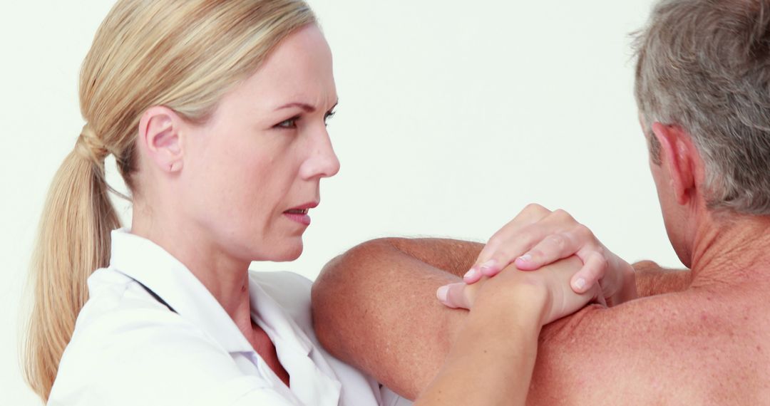 Female Physical Therapist Providing Shoulder Rehabilitation to Elderly Man - Free Images, Stock Photos and Pictures on Pikwizard.com