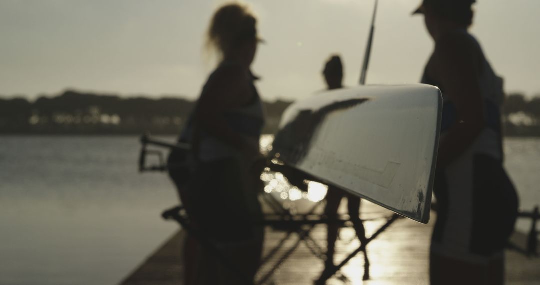 Team of Rowers Preparing Boat for Training on Lake at Sunrise - Free Images, Stock Photos and Pictures on Pikwizard.com