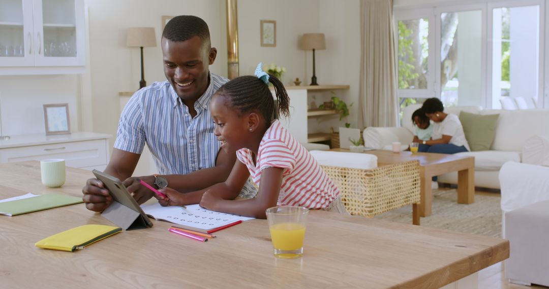 Father and Daughter Collaborating on Homework With Tablet at Home