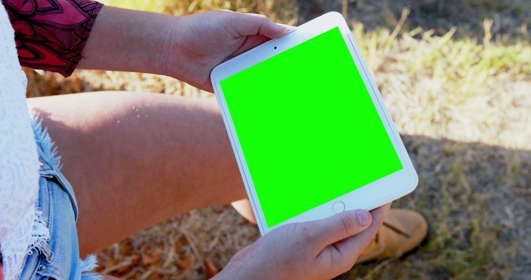 Person Holding a Tablet with Green Screen Outdoors - Free Images, Stock Photos and Pictures on Pikwizard.com