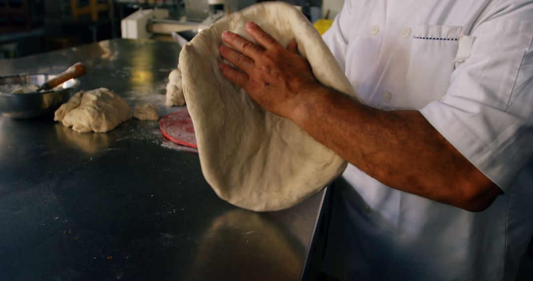 Baker Shaping Dough by Hand in Professional Kitchen, Perfecting the Craft - Free Images, Stock Photos and Pictures on Pikwizard.com