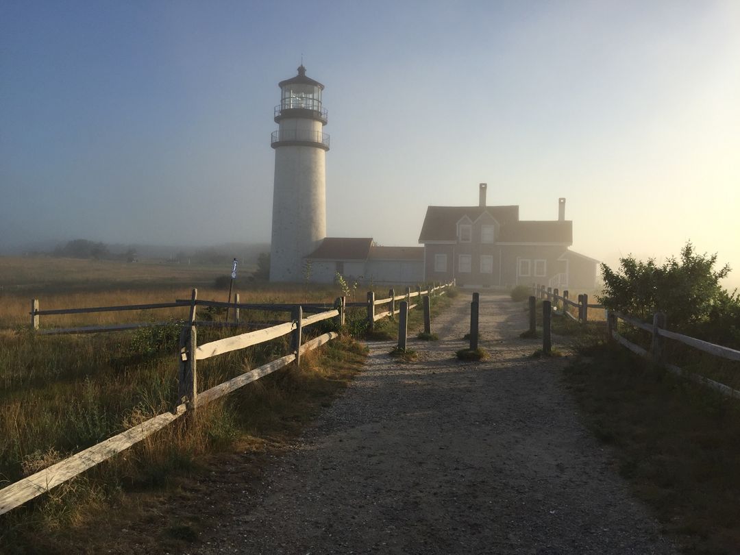 Foggy Lighthouse with Gravel Pathway at Dawn - Free Images, Stock Photos and Pictures on Pikwizard.com
