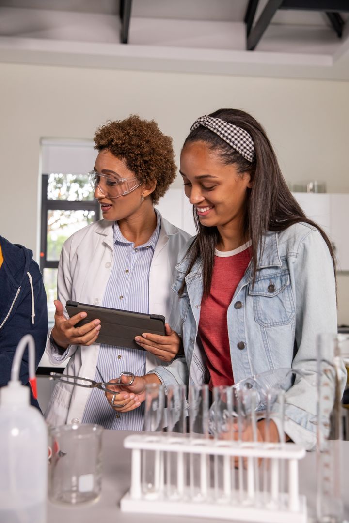 Female Instructor Teaching Science to Teenage Student in Modern Lab