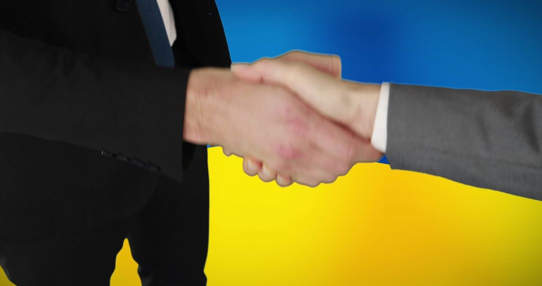 Business Handshake Over Ukraine Flag Symbolizing Cooperation