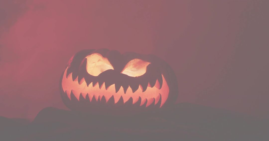 Glowing Jack-o'-Lantern with Jagged Teeth and Crimson Low-Key Halloween Mood