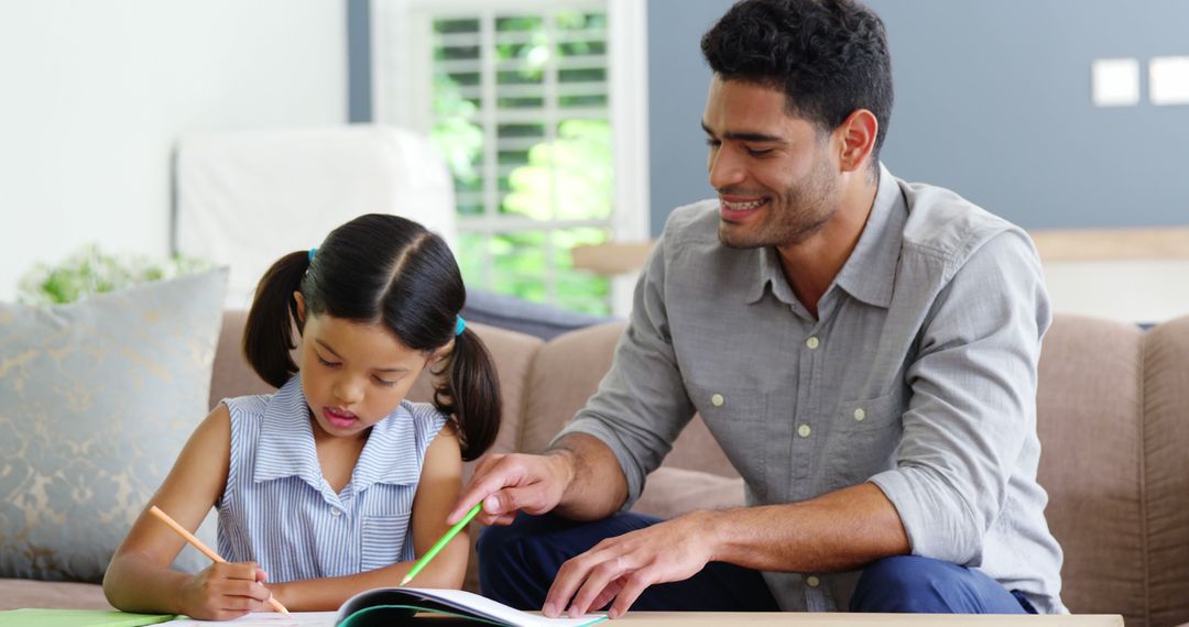 Father Helping Daughter with Homework in Living Room - Free Images, Stock Photos and Pictures on Pikwizard.com