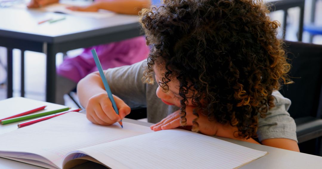 Curly Haired Child Concentrating on Classroom Task