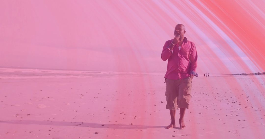 Senior Man in Pink Embracing Tranquil Beach Walk