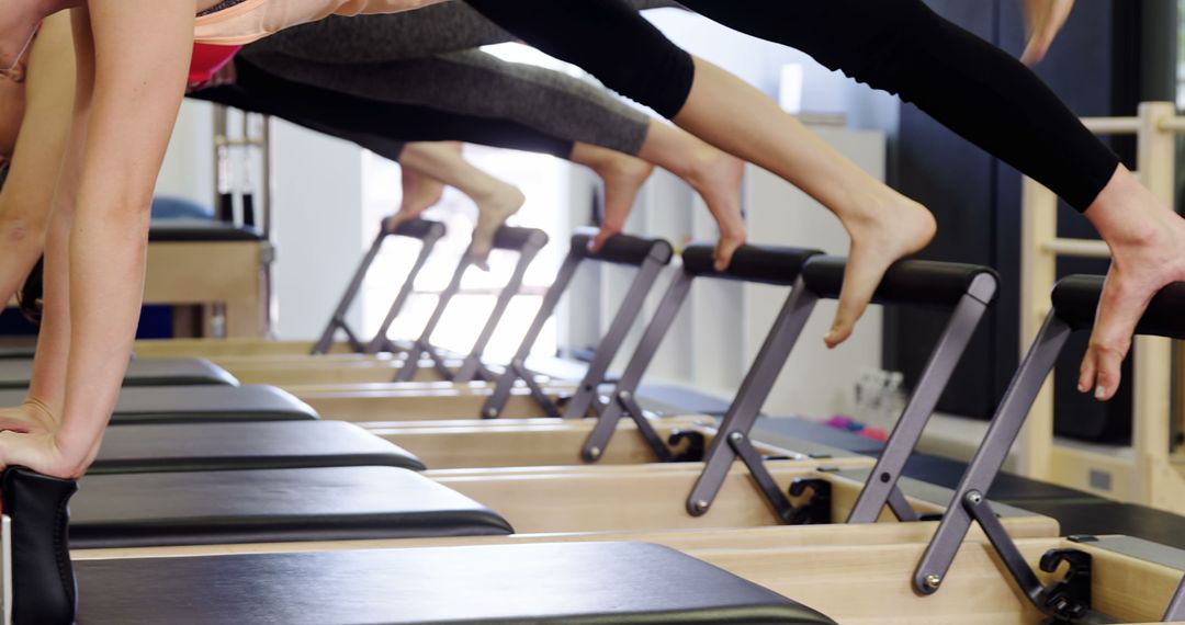 Women Exercising on Reformer in Pilates Studio - Free Images, Stock Photos and Pictures on Pikwizard.com