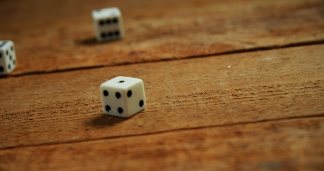 Close-up of Rolling Dice on Wooden Table - Free Images, Stock Photos and Pictures on Pikwizard.com